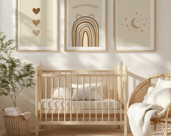 May include: Three framed art prints with a neutral color palette. One print features three hearts, another has a rainbow with the text "Hello Sunshine!", and the third displays a crescent moon and stars. A wooden crib and wicker chair are in the foreground.