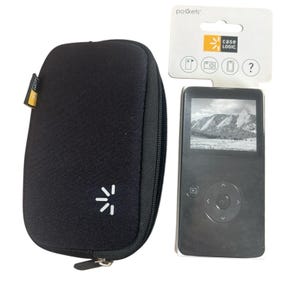May include: Black digital media player with a screen displaying a black and white mountain landscape, next to a black zippered case with a white graphic. A Case Logic tag is visible.