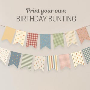 May include: A birthday party setup with a banner reading "Print your own BIRTHDAY BUNTING." The bunting has patterned flags. A cake with lit candles, party hats, and striped straws are on a yellow cart, ideal for a celebration.