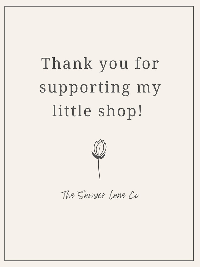 May include: A cream-colored card with the text "Thank you for supporting my little shop!" in a serif font. Below the text is a simple line drawing of a flower and the words "The Sawyer Lane Co."