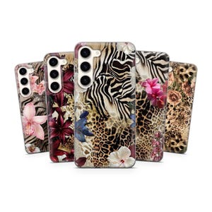 May include: A collection of five phone cases with unique designs. The cases feature a mix of animal prints, including zebra and leopard patterns, and floral accents in various colors. The cases are designed to fit a specific phone model.