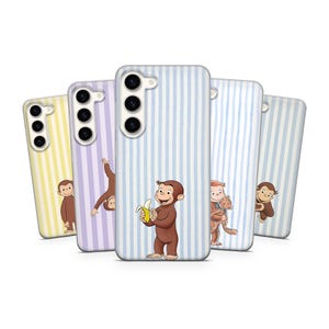 May include: A collection of phone cases featuring a cartoon monkey character. The cases have striped backgrounds in various colors, including yellow, purple, and blue. The monkey is holding a banana on one of the cases.