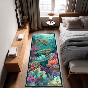 May include: A rectangular area rug featuring an underwater scene with three sea turtles swimming above colorful coral reefs. The rug has a dark green border and is designed for a bedroom or living space.