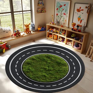 May include: A round children's rug with a road design. The outer ring is black with white dashed lines, simulating a road. The center features a patch of green, artificial grass. The rug is in a playroom with toys.