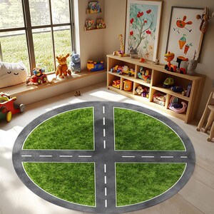 May include: A round children's play rug with a road design. The rug features a gray asphalt road with white dashed lines intersecting over a green grass-like surface. The rug is in a playroom with toys and a window.
