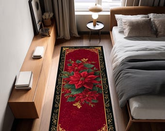 Op de afbeelding: Een rechthoekig rood tapijt met een zwarte rand en een gouden filigraan ontwerp. Het tapijt heeft een centrale bloemstuk van rode poinsettia's en groene bladeren, waardoor een feestelijk vakantiethema ontstaat.