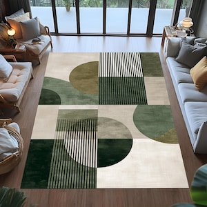 Peut inclure: Tapis rectangulaire avec un motif géométrique moderne. Il présente des blocs de couleurs vert olive, vert foncé, beige et blanc. Le design intègre des demi-cercles et des rayures verticales, créant une esthétique contemporaine.