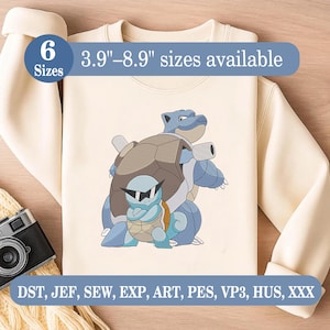 May include: Cream-colored sweatshirt featuring a blue cartoon turtle design. The design includes two turtles, one larger and one smaller, with the smaller turtle wearing sunglasses. Text on the image indicates sizes available from 3.9" to 8.9".
