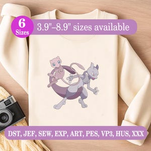 May include: A cream-colored sweatshirt featuring a graphic of the pink creature Mew and the purple creature Mewtwo. The image includes text stating 6 Sizes and 3.9"–8.9" sizes available, along with file formats DST, JEF, SEW, EXP, ART, PES, VP3, HUS, XXX.
