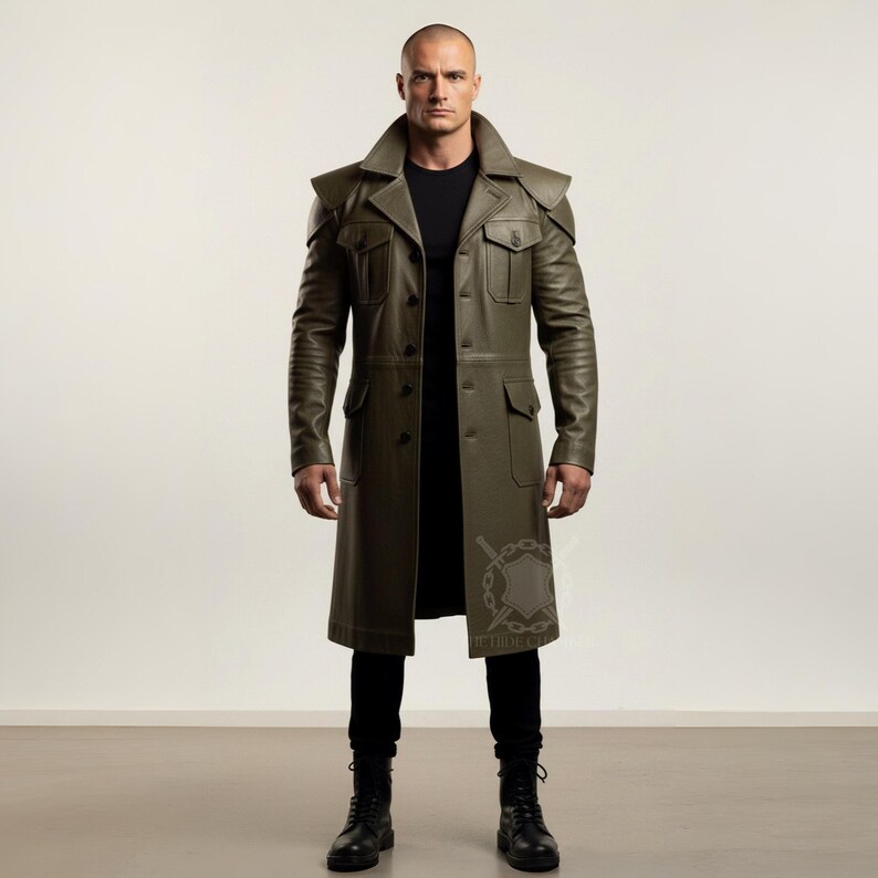 May include: Olive green leather coat with a classic trench coat design. Features a notched collar, shoulder epaulets, multiple pockets, and a button-down front. The coat is knee-length and worn with black pants and boots.