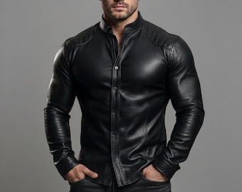 May include: A black leather shirt with a mandarin collar and button-up front. The shirt features quilted shoulder detailing and long sleeves. The model is wearing the shirt with their hands in their pockets.