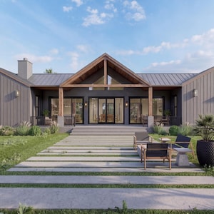 May include: Exterior view of a modern, single-story house with a gray facade and a gabled roof. The house features large windows and a covered porch with wooden beams. A stone pathway leads to the entrance, and the yard is landscaped with grass and plants.