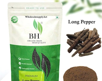 Puede incluir: Imagen de pimienta larga, entera y en polvo, con el texto "Long Pepper Whole and Powder". El empaque es blanco y verde, con el logo "BH" y las palabras "Organic Seeds High Quality". También se muestran pimientas largas enteras y un montón de polvo.