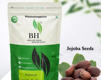 May include: A packet of premium Jojoba seeds, with the text "READY TO USE" and "WholesalesupplyArt". The packet is white and green with the words "BH ORGANIC SEEDS HIGH QUALITY". Beside the packet are brown Jojoba seeds and green leaves.