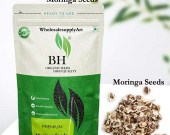 May include: A package of premium Moringa seeds with the text "Moringa Seeds" and "BH Organic Seeds High Quality". The package is white and green with a natural product seal. A pile of Moringa seeds is next to the package.