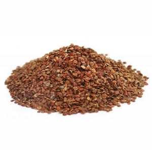 May include: A pile of small, reddish-brown seeds against a white background. The seeds are oval-shaped and appear to be dried. The image is a close-up, showing the texture and color variations within the seed pile.