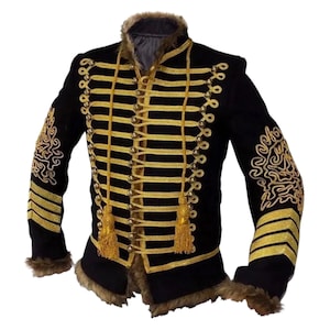 May include: Black military-style jacket with gold trim and accents. The jacket features gold braid, tassels, and decorative embroidery on the sleeves. The collar and cuffs are trimmed with faux fur.