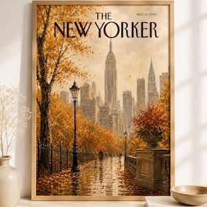 May include: A framed print of a New Yorker magazine cover dated October 15, 2023, featuring an autumn scene in New York City with golden trees, a wet pathway, a black lamppost, and the city skyline in the background under a soft sky.