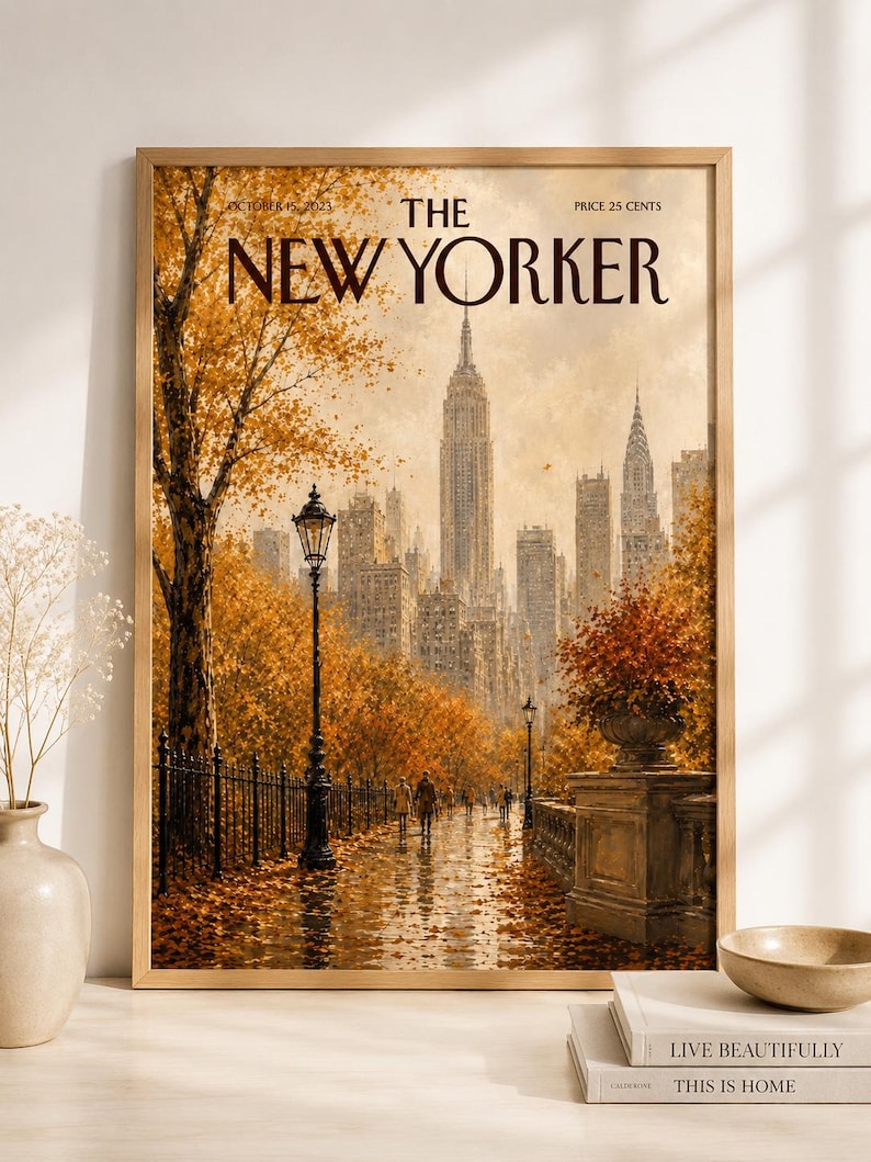 May include: A framed print of a New Yorker magazine cover dated October 15, 2023, featuring an autumn scene in New York City with golden trees, a wet pathway, a black lamppost, and the city skyline in the background under a soft sky.