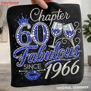 May include: A black t-shirt featuring a blue and white rhinestone graphic that reads Chapter 60 Fabulous Since 1966. The design includes a crown, two wine glasses, and a pair of lips, all rendered in a sparkling, gem-like blue and white pattern.