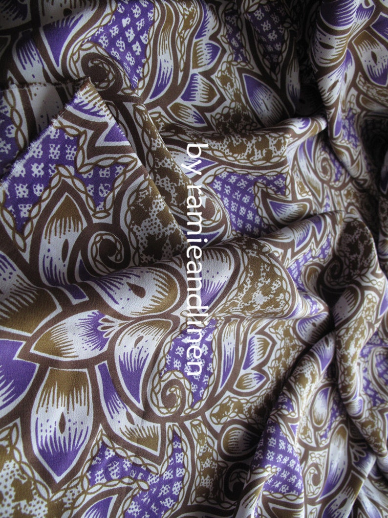 May include: Purple and brown patterned fabric with a paisley design. The fabric is made of ramie and linen.