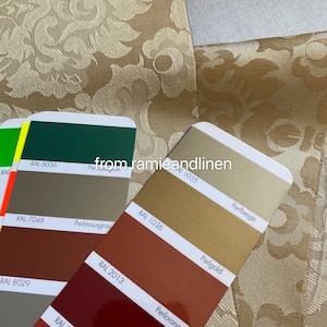May include: A set of color swatches with RAL numbers and names. The swatches are arranged in a vertical column, with the top swatch being green, followed by gray, brown, and red. The names of the colors are written below each swatch, including "Perlgrun", "Perlmausgrau", "Perlorang", and "Perlbeige".
