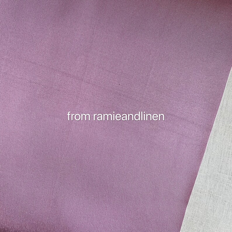 May include: Close-up of a soft, mauve fabric with a subtle sheen. The fabric is smooth and has a slightly textured surface. The text "from ramieandlinen" is visible in the lower center of the image.
