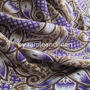 May include: Purple and brown patterned fabric with a paisley design. The fabric is woven and has a soft, drapey texture.