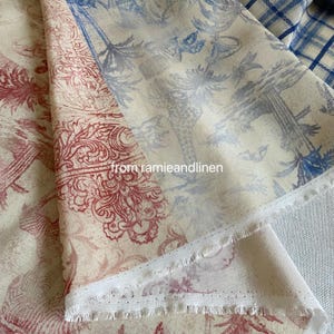 May include: Close-up of fabric with a botanical print in red and blue hues. The fabric features a repeating pattern of trees and floral designs. The text "from ramieandlinen" is visible on the fabric.