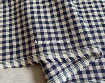 May include: A close-up of a blue and white gingham fabric with a frayed edge. The fabric has a subtle sheen and a slightly textured surface. The text "from ramieandlinen" is visible in the lower left corner of the image.