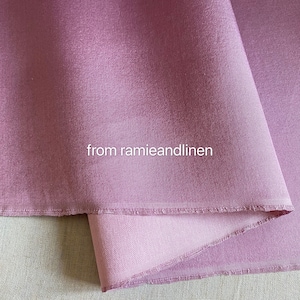 May include: A close-up of a soft, mauve-colored fabric with a subtle texture. The fabric is folded over, revealing a lighter shade of mauve underneath. The text "from ramieandlinen" is visible in the center of the image.