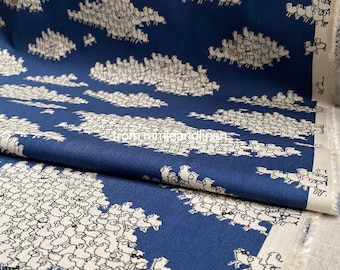 May include: Blue fabric with a white repeating pattern of sheep forming clouds. The fabric has a white border.