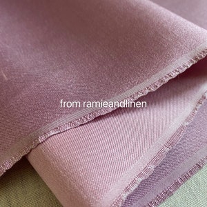 May include: Close-up of a soft, pink fabric with a subtle sheen. The fabric has a delicate, woven texture and a slightly textured edge. The text "from ramieandlinen" is visible in the lower center of the image.