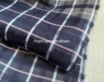 May include: A close-up of a navy blue and white checkered fabric with a pink stripe. The fabric is folded in half and the edges are frayed. The text "from ramieandlinen" is visible in the lower left corner of the image.