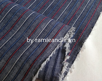 May include: Striped fabric in shades of blue, red, and white. The fabric has a textured, woven look and a raw edge. The text "by ramieandlinen" is visible in the lower center of the image.