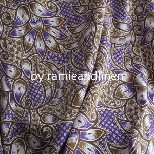 May include: Purple and brown patterned fabric with a paisley design. The fabric is made of ramie and linen.