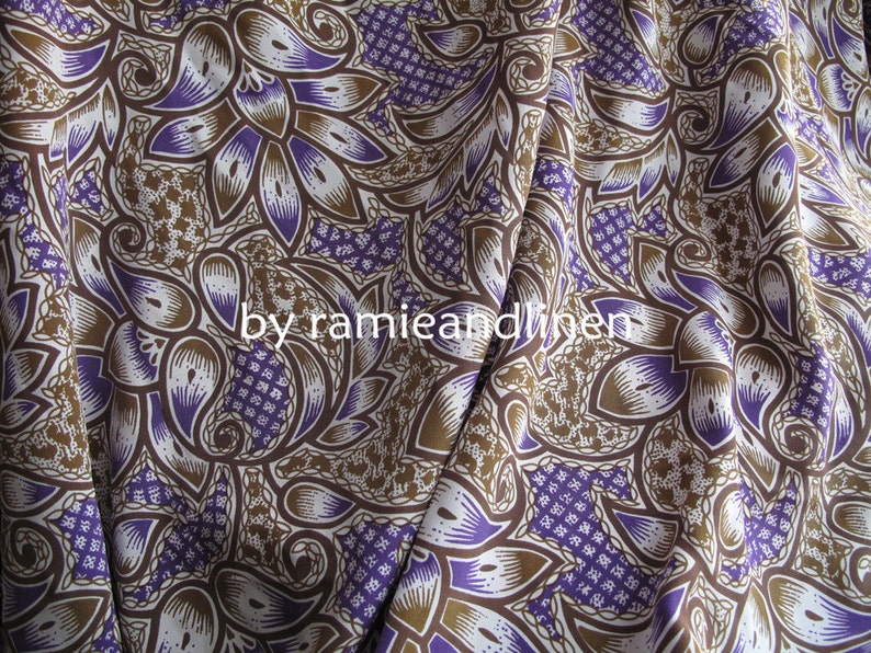 May include: Purple and brown patterned fabric with a paisley design. The fabric is made of ramie and linen.