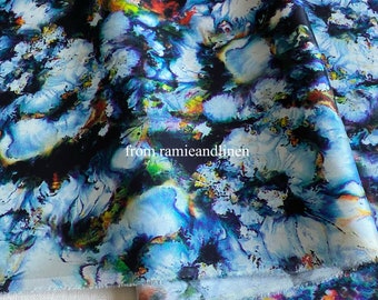 May include: Abstract floral print fabric in shades of blue, black, green, and yellow. The fabric has a watercolor effect and is perfect for crafting and sewing projects.