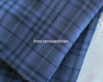 May include: A close-up of a blue and black plaid fabric. The fabric is folded in half and the text "from ramieandlinen" is visible in the center of the image.