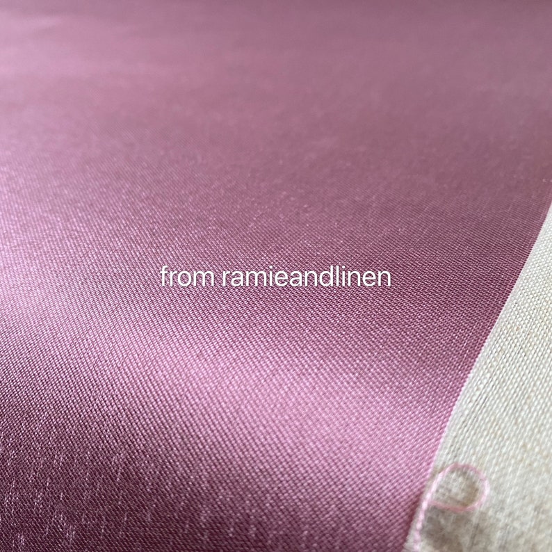 May include: Close-up of a smooth, deep pink fabric with a subtle texture. The fabric is a solid color and has a slight sheen. The text "from ramieandlinen" is visible in the lower center of the image.