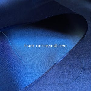 May include: Close-up of a dark blue fabric with a lighter blue fabric folded over it. The text "from ramieandlinen" is visible in the center of the image.