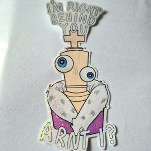 May include: A sticker featuring a cartoon character with large blue eyes, a light tan body, and a purple and white fur-trimmed coat. The text "I'M RIGHT BEHIND YOU" is above the character, and "ARN'T I?" is below.