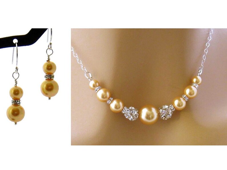 May include: A gold pearl necklace and matching earrings with crystal accents. The necklace features a row of pearls with crystal accents in between each pearl.