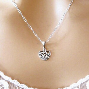 May include: A silver necklace with a heart-shaped pendant that says "Mom" in a cursive font.