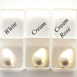 May include: Three white pearl samples in a white tray. The samples are labeled "White", "Cream", and "Cream Rose".