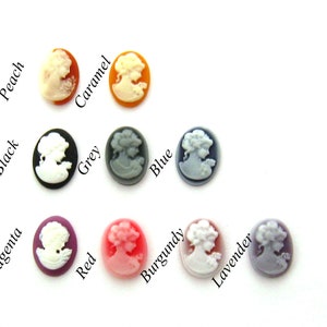 May include: Assortment of 12 cameo-style buttons in various colors, including black, grey, blue, red, burgundy, lavender, peach, caramel, and magenta. Each button features a white cameo profile.
