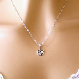 May include: A silver necklace with a heart pendant that says "Mom" on it.