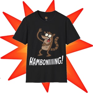 May include: A black short-sleeved t-shirt featuring a graphic of a brown cartoon raccoon with a striped tail, appearing startled with hands raised. Below the character, the word HAMBONIIIIING! is printed in bold white capital letters.