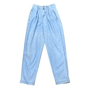 May include: Light blue acid wash denim jeans with a high waist and pleated front. The jeans have two front pockets and a button and zipper closure. The denim pants are a vintage style.
