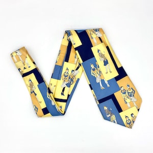 May include: A vintage necktie with a repeating pattern of figures in yellow, blue, and navy blue. The tie is made of a silky material and is displayed on a white background. The figures are dressed in vintage clothing.